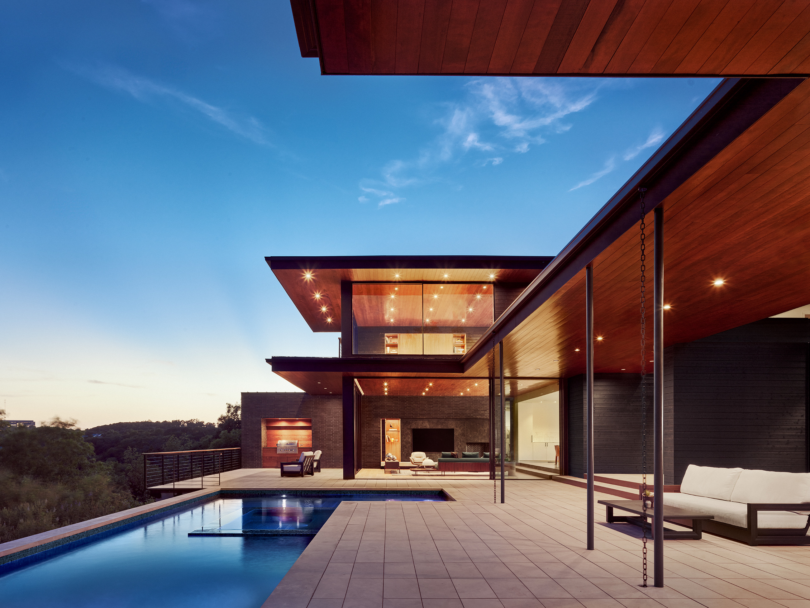 Modern Austin home with a pool at dusk